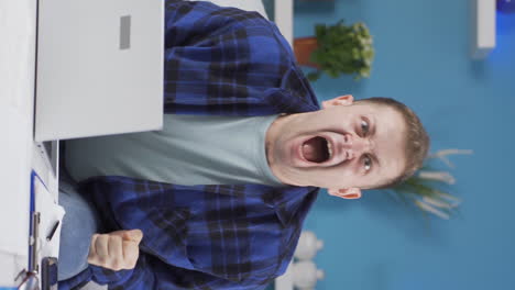 Vertical-video-of-Home-office-worker-man-having-a-nervous-breakdown.