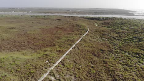 Flying-over-the-retaining-wall-of-the-grasslands-which-is-diagonal-to-the-camera