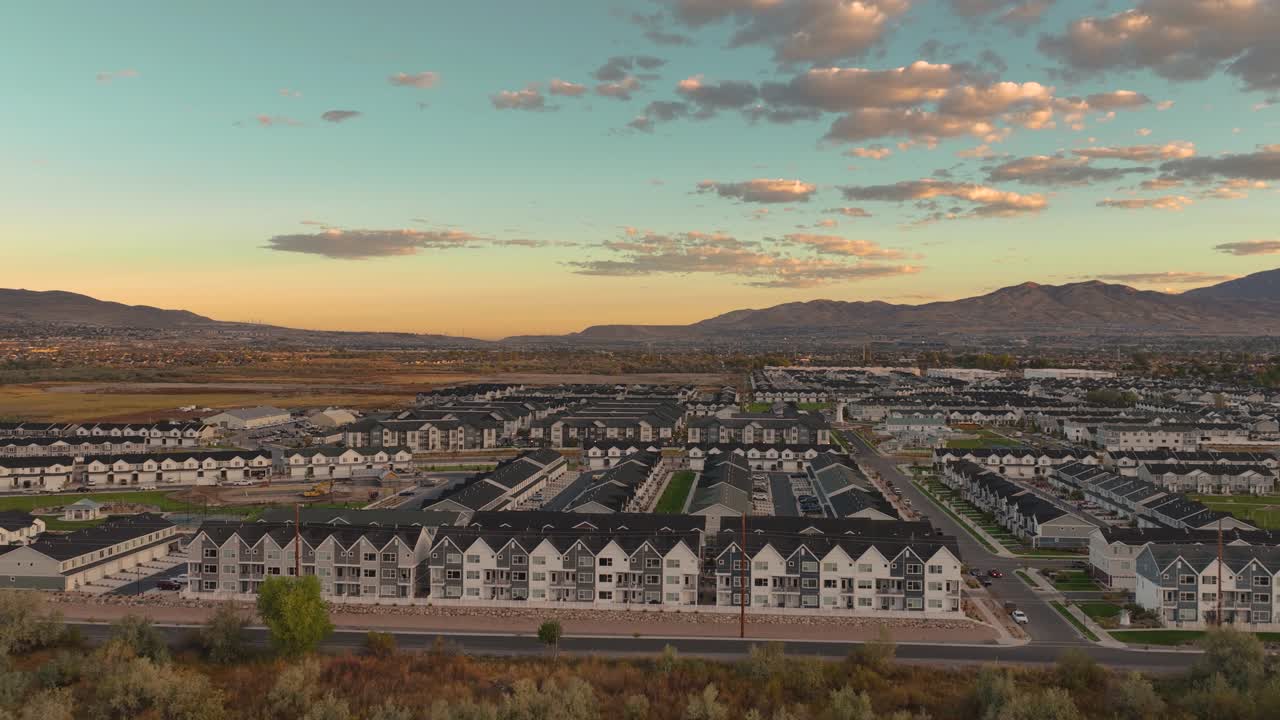 Sliding Aerial Shot Of Townhouses In A New Neighborhood Development At Sunrise In Saratoga Springs, Utah