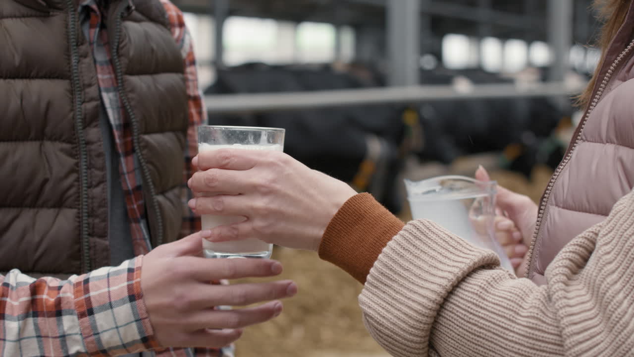 Close Up of Pouring Milk into Glass at Dairy Farm