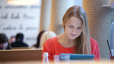 Woman-in-cafe-with-touchpad