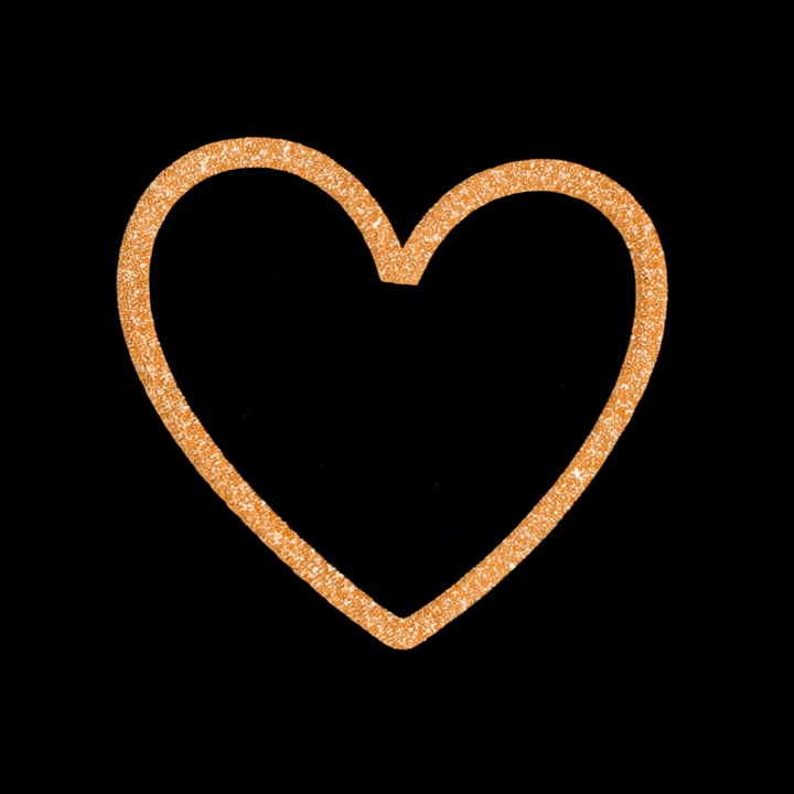 Cuore luminoso con glitter dorati su sfondo nero