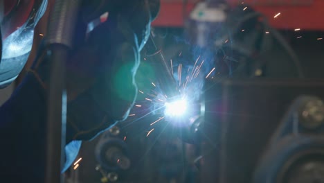 extreme close up hand welding in slow motion, industrial metal shop