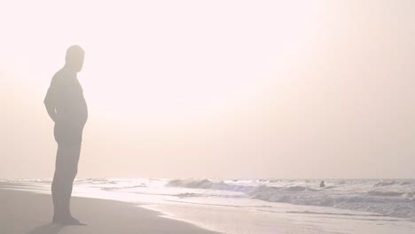 silhouette of a man on the seashore during sunset