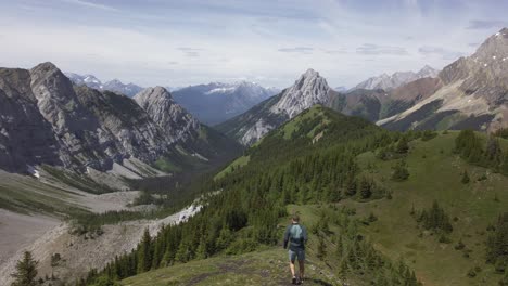 hiker jogging down the mountain on mountain range rockies kananaskis alberta canada