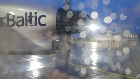 air baltic plane at airport in rain