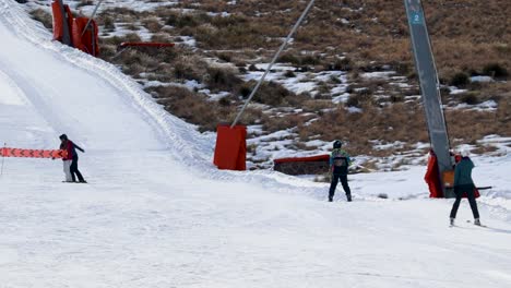 winter vacation, skiers on a t-bar ski lift