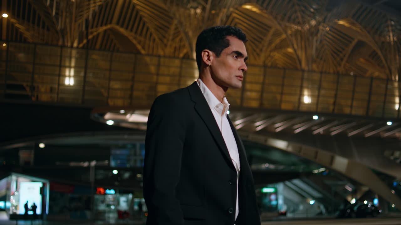 Confident businessman going evening airport place. Serious model walking night