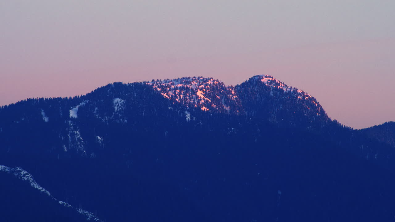 The misty blue mountain landscape as seen from the Capitol Hill Reservoir Park in Canada - wide shot