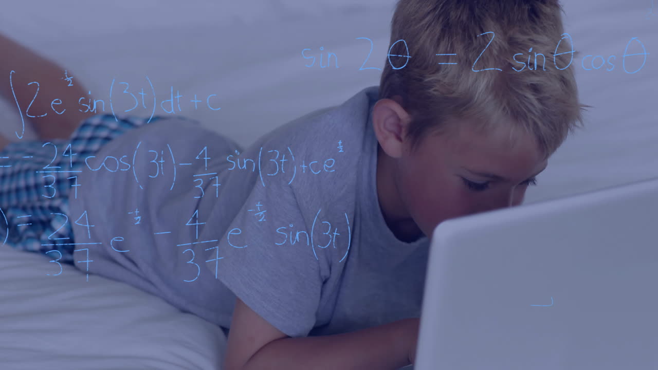 Mathematical equations animation over boy using laptop while lying on bed