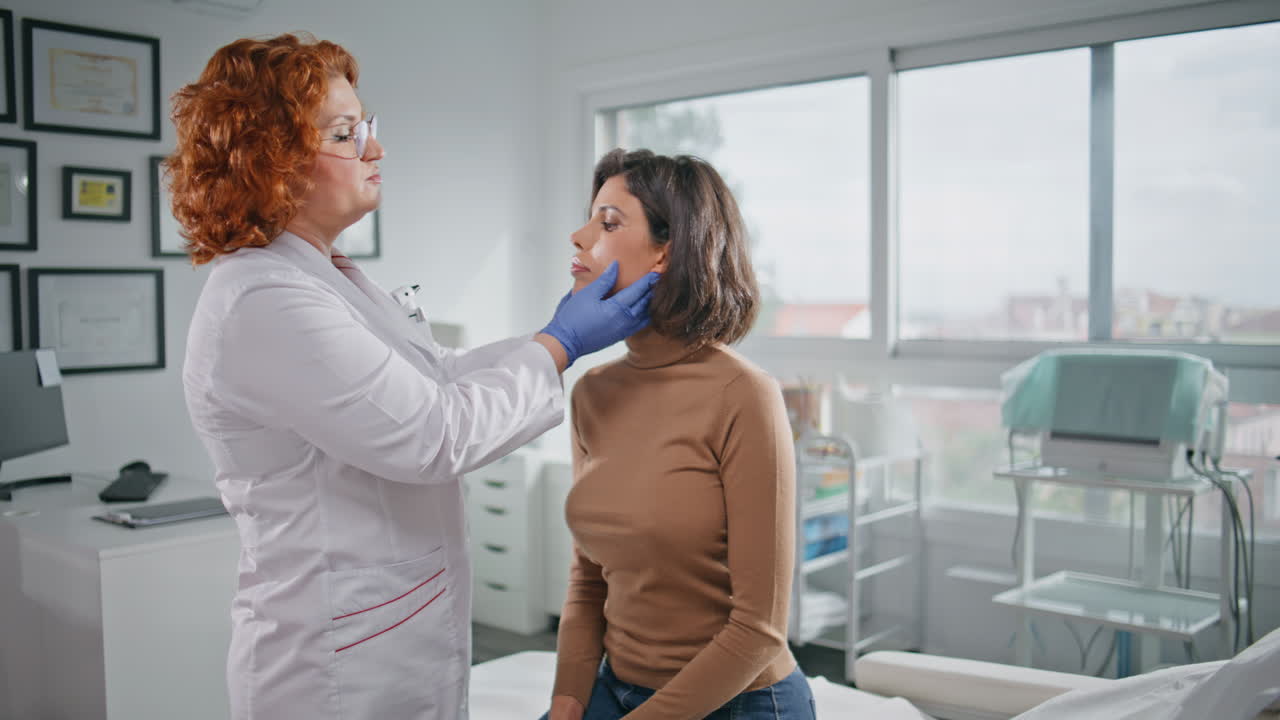 Doctor palpating woman neck healthcare clinic. Specialist making health checkup