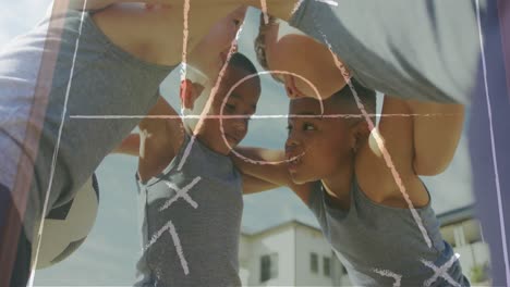 animation of game tactics over happy diverse schoolboys with football in huddle