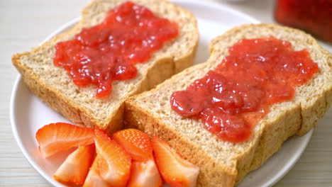 homemade whole wheat bread with strawberry jam and fresh strawberry