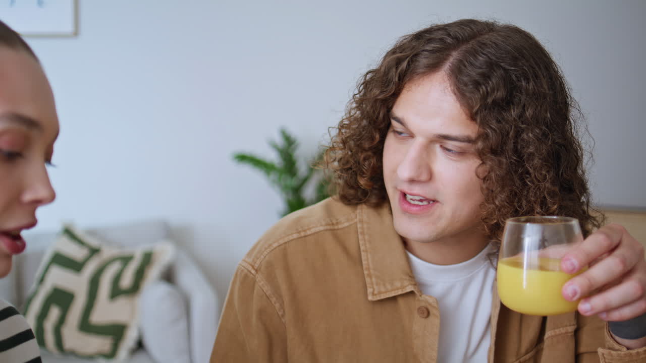 Family couple drinking juice in modern kitchen at morning closeup. Happy pair