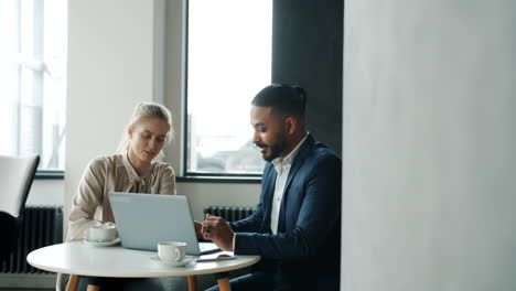 business colleagues discussing project in a modern cafe