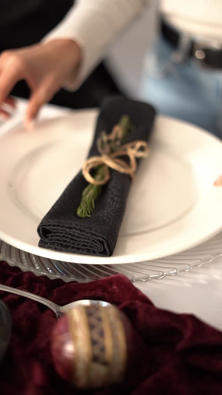 An elegant table setting with a plate and a wrapped napkin tied with string, close up shot