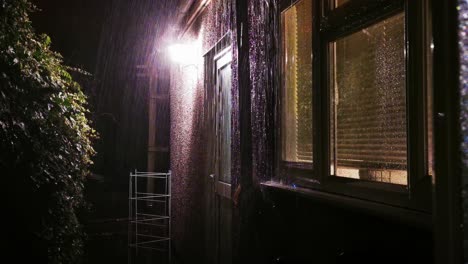 a view of a uk back garden in the night time during a heavy rainy downpour