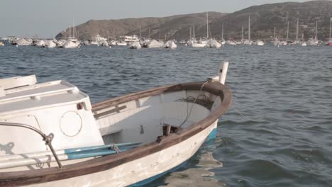 Small-boat-docked,-floating-on-harbor-port-in-Spain