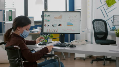 Employee-with-disabilities-working-for-deadline-project-wearing-face-mask