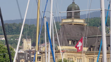 sailing ship masts, swiss flag blowing in the background