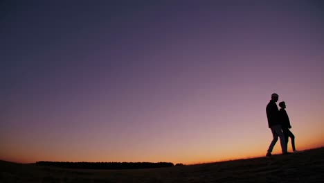 couple walking at sunset
