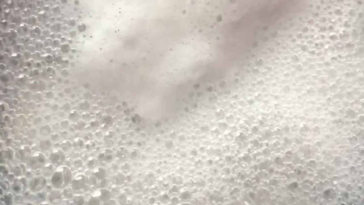 Close up overhead view of boiling , bubbly and foamy water