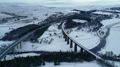 aerial view of railway and motorway bridges spanning wide valley with river findhorn