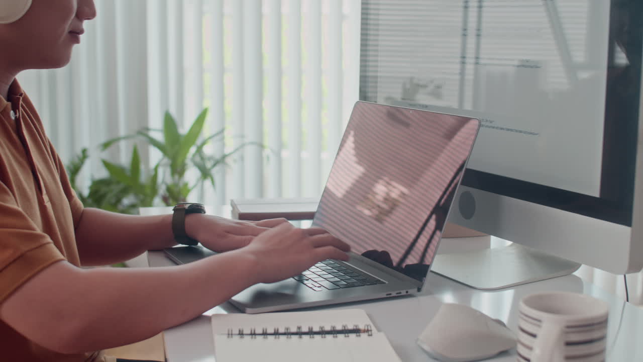 Portrait of Young Coder Testing Software App on Laptop