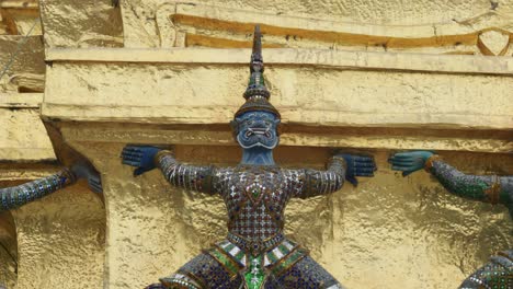 4k cinematic religious travelling footage of yak statues at the temple of the emerald buddha wat phra kaew in bangkok, thailand on a sunny day