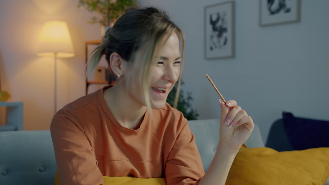 Woman enjoying a snack at home