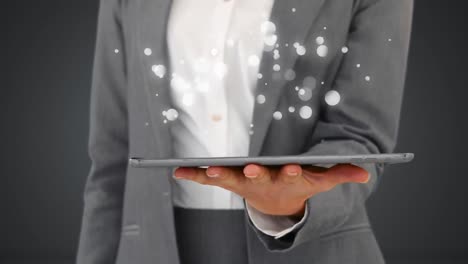 Businesswoman-using-digital-tablet-surrounded-by-white-bubbles-effect