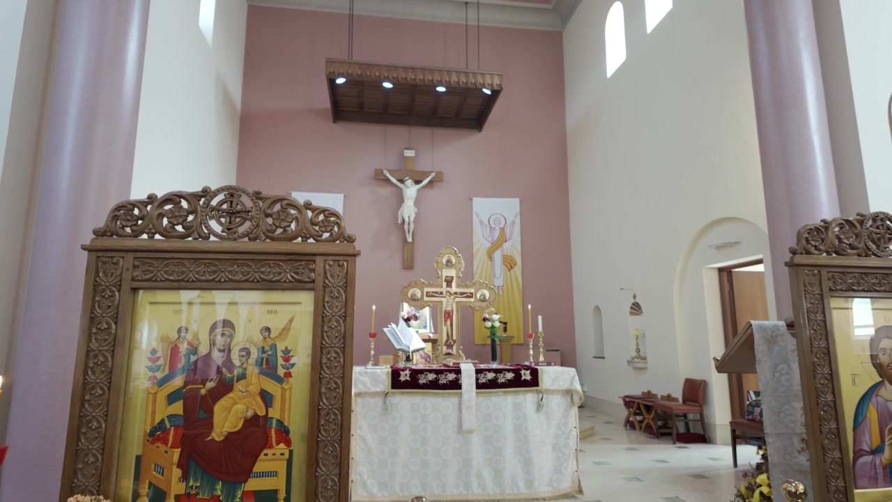 Rückwärtsfahrt enthüllt einen katholischen Kirchenaltar mit Kruzifix und religiösen Ikonen