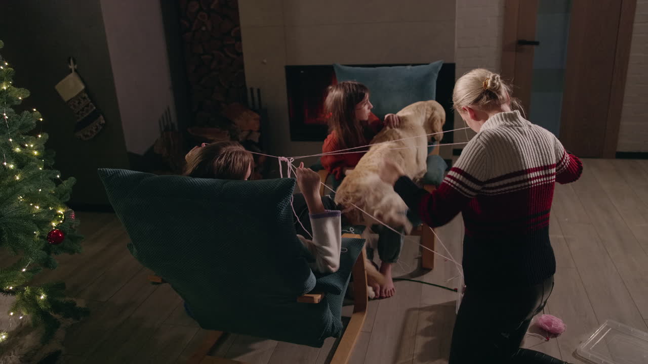 Family with golden retriever around Christmas tree