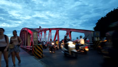 famous eiffel "truong tien" bridge in hue, vietnam. timelapse at the dusk with numerous motorbike crossing the river of perfume.