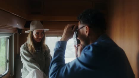 couple taking photos in a campervan