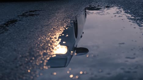 reflection of car in puddle.