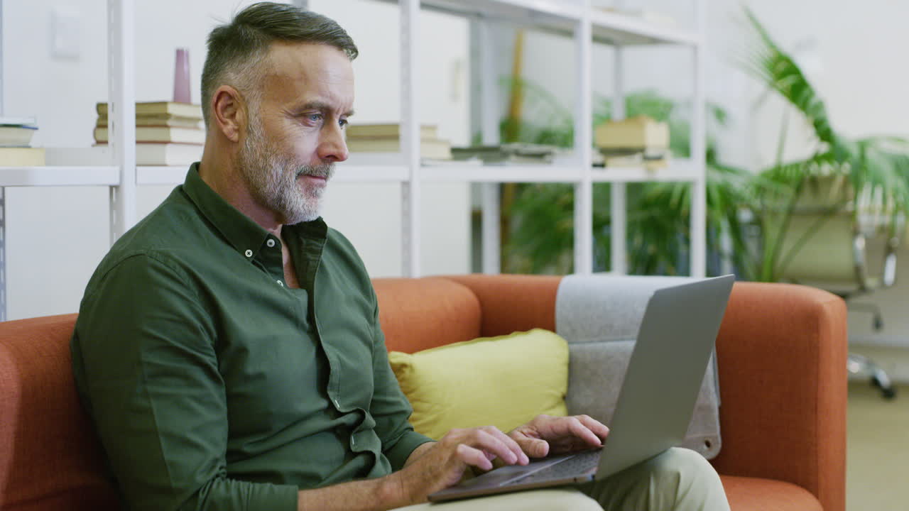 Mature businessman using a laptop to search