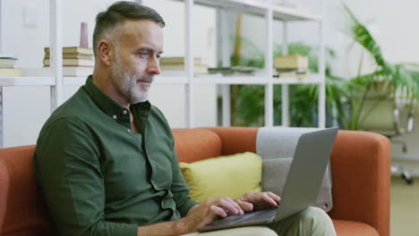 mature businessman using a laptop to search