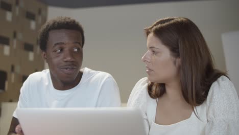 couple of startup managers sitting at table with laptop