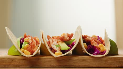 chicken tacos with avocado, corn, and red cabbage