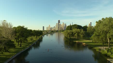 person rowing on summer day with chicago skyline in background