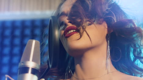 woman singing in a recording studio. female vocals. professional recording studio. slow motion
