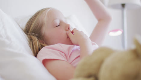side view of caucasian girl waking up on bed