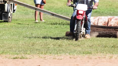 motorcyclist navigating various obstacles on a course