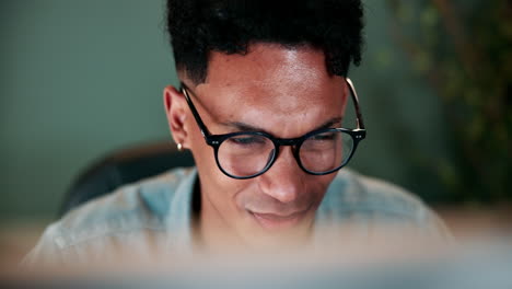 man working on computer, focused but potentially tired