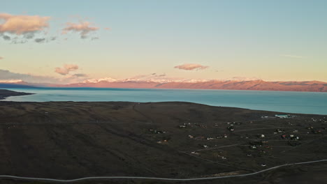 beautiful sunset over the andes mountains in patagonia, argentina.aerial drone view of electric blue lake and dreamy colorful sky as the sun sets