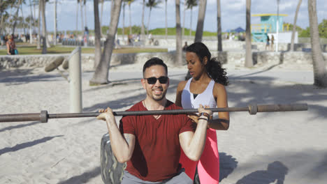 Girl-training-man-in-beach-gym