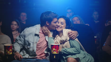 happy couple watching movie in cinema