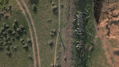 vertical aerial tracks hiker walking along old, disused railway track