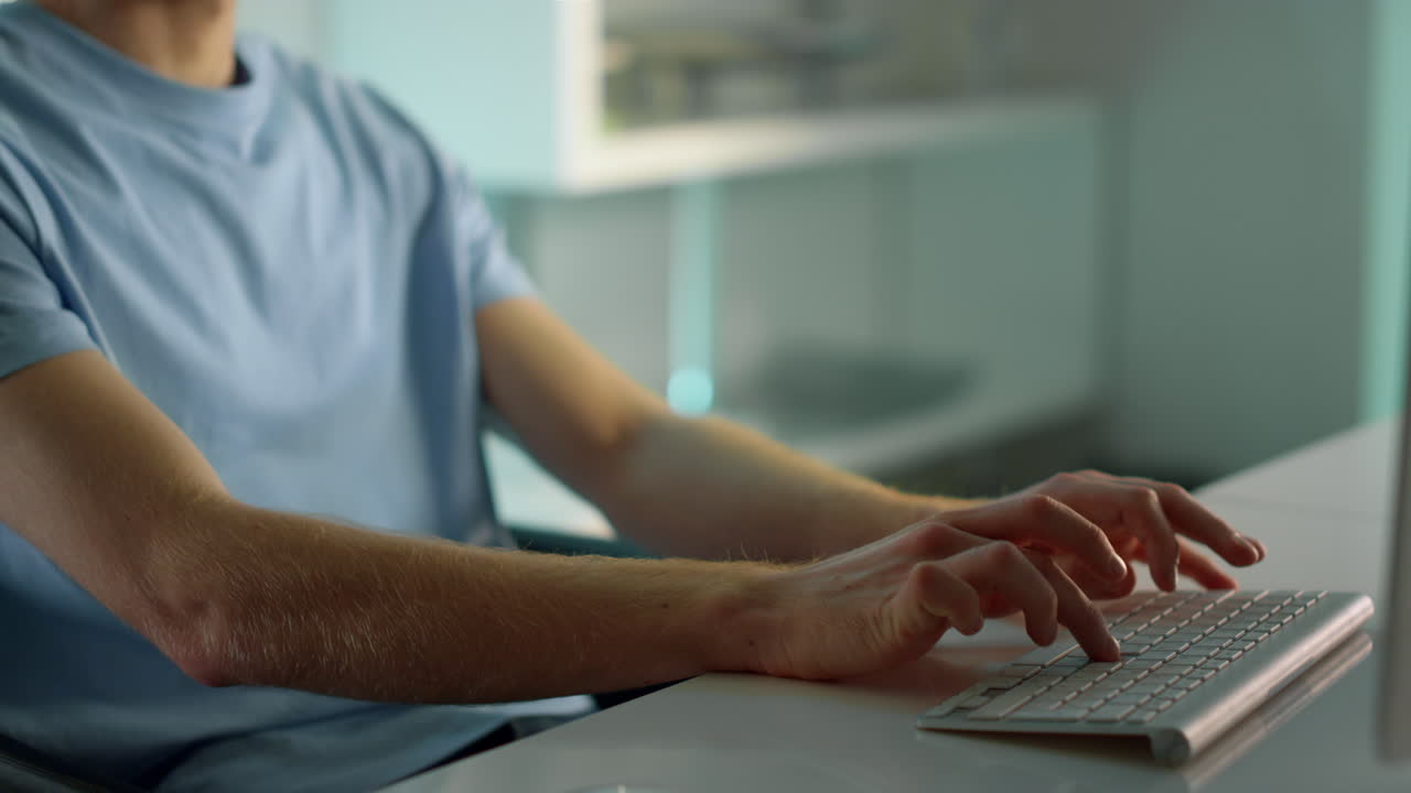 Closeup hands typing computer keyboard. Focused man writing email at home office